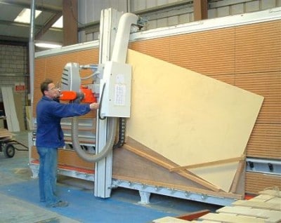 Mill team leader Jonathan Eveleigh uses a home-made jig to cut shaped barge end plywood panels on the Striebig Control at Wessex Homes.